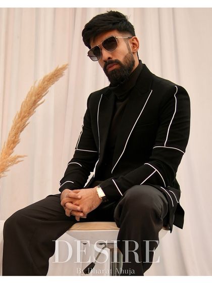 A classic black blazer set is a statement of confidence. This one features subtle white piping for a modern twist on a timeless look.