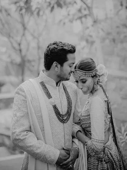 A tender black and white portrait from a wedding in Udaipur. The groom's gentle gaze and the bride's serene expression tell a story of comfort and deep affection.