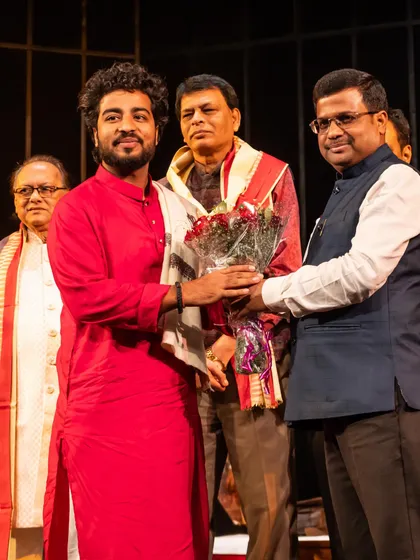 Being felicitated with a bouquet of flowers at the Debadhara Festival.