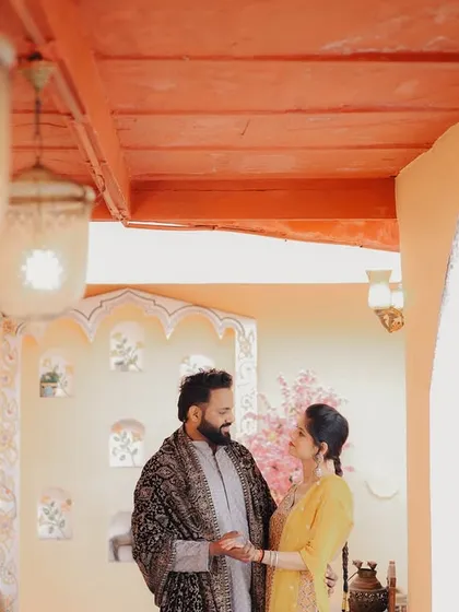 A romantic indoor shot in a beautifully designed studio space. The warm lighting and elegant decor create a sophisticated atmosphere.