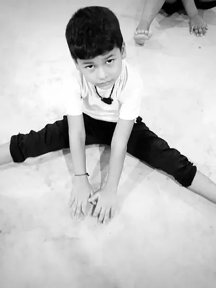 A black and white shot emphasizing the form and effort of the stretch.