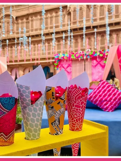 Custom-printed paper cones filled with rose petals for guests to shower the couple, each with a unique Rajasthani block print design.