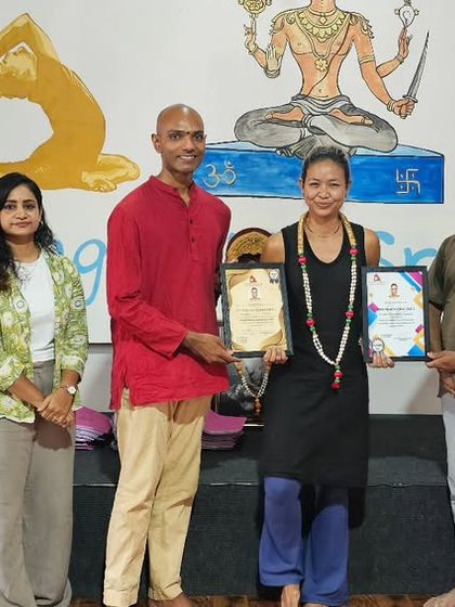 A graduate from the Thailand batch receives her certificate, marking the successful completion of her intensive training.
