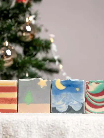 A selection of the more traditionally shaped Christmas soaps. The image captures the beautiful colors and patterns, from swirls to stripes.