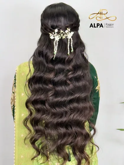 A beautiful half-up hairstyle for long hair, adorned with a delicate handmade white floral and pearl hair clip.