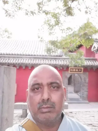A quiet moment within the Shaolin Monastery premises in China. The red walls and traditional architecture are iconic symbols of Shaolin.