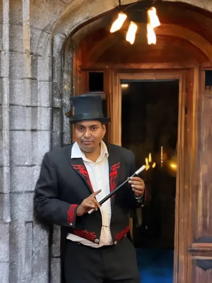 A classic magician pose with a flaming wand. This image captures the traditional and mysterious side of the magical arts.