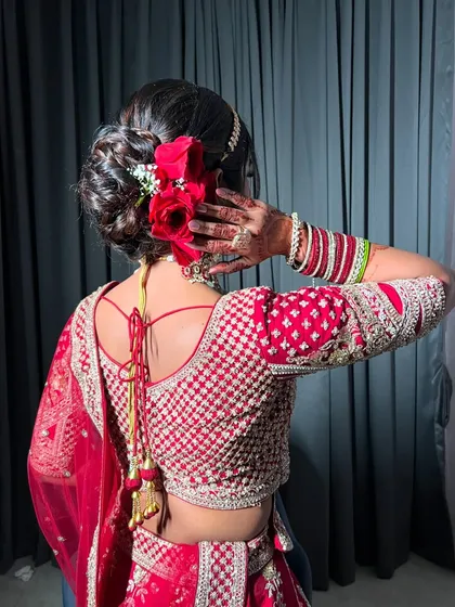 Another angle of the beautiful floral bun, a timeless choice for a classic red lehenga look.