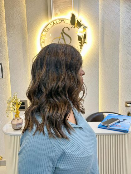 A side view of the caramel blond, highlighting the warm tones and soft, wavy texture.