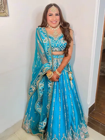 This cute bride-to-be is glowing for her Sangeet. We went for a fun and glamorous look with a pop of color on the eyes to match her vibrant blue lehenga.