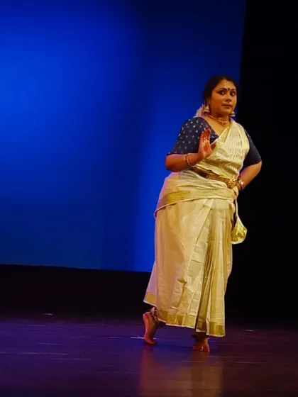 A dancer captured mid-movement, demonstrating the gentle sway and poise that is a hallmark of our Mohiniyattam style.