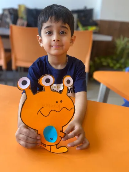 Look at that proud smile! After a fun crafting session in our Speech & Drama class, this little artist proudly shows off the friendly monster he created. These activities are fantastic for boosting creativity and fine motor skills.
