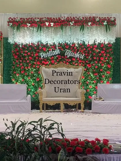 A classic combination of red and green for a timeless wedding stage. We created a full floral wall with red roses as the centerpiece, framed by green foliage panels and elegant gold-trimmed arches for a luxurious feel.