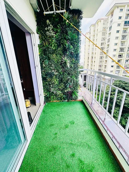 Even a small apartment balcony can become a private green escape. We installed a dense, multi-layered vertical garden and soft artificial grass to completely transform this high-rise space into a cozy, green nook.