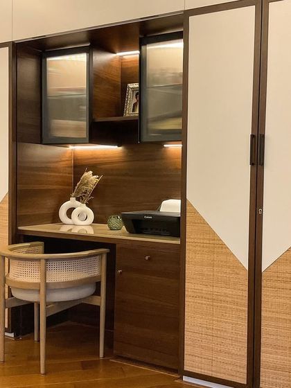 A before-and-after of a study desk transformation. We turned a simple wall into a beautiful and functional workspace with custom cabinetry and lighting.