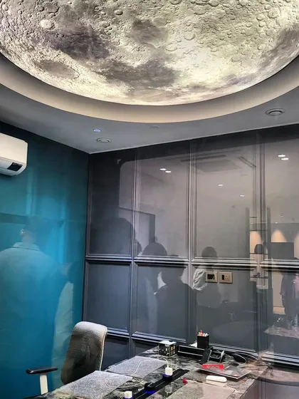 Why settle for ordinary when you can have the extraordinary? This unique moon-themed ceiling light in our office is an example of how we use creative lighting solutions to make a bold design statement.