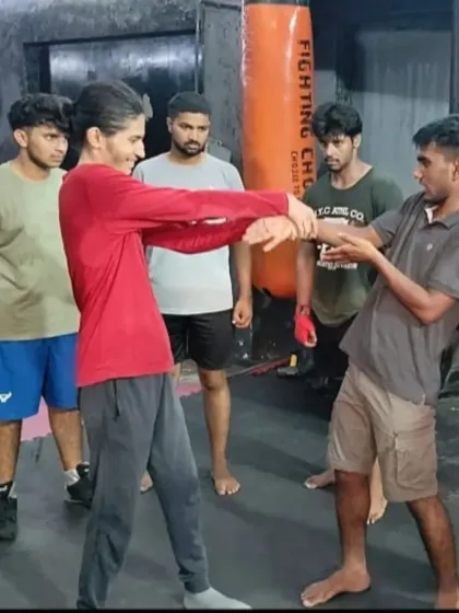 The completion of the wrist lock technique, showing how to control an attacker's posture and movement.