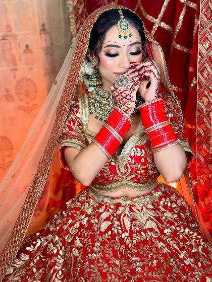 A candid shot capturing the bride's shy smile. The makeup is designed to look beautiful from every angle.