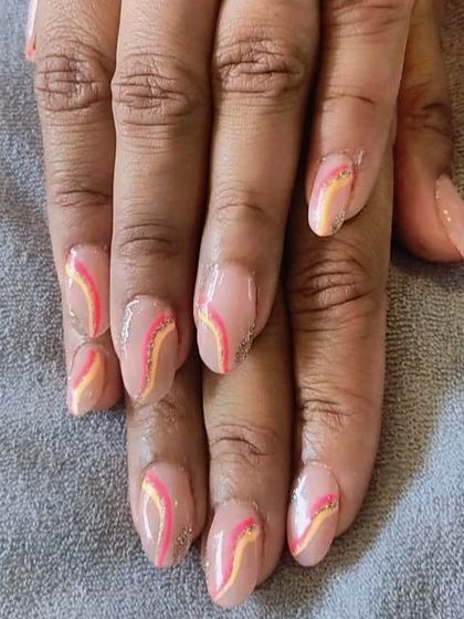 This design features delicate, wavy lines in shades of pink and yellow with a hint of glitter over a nude base. It's a soft and artistic look, perfect for someone wanting subtle nail art.