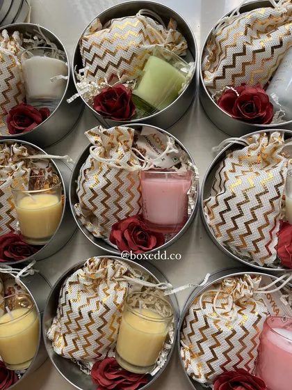 Another view of the contents of the wedding return favours, showing the variety of colorful candles and small gifts.