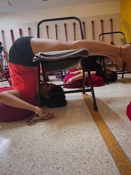 Part of a de-stress sequence: Supported Halasana on a chair. This pose calms the brain and nervous system, helping to relieve the physical and mental symptoms of stress.