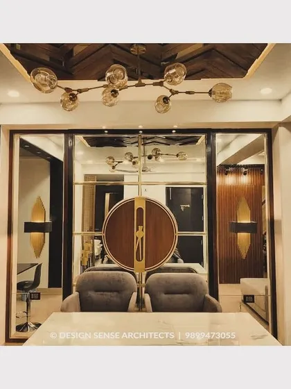 A detail shot of a dining area partition, featuring a unique circular motif in wood and brass that separates the space while maintaining an open feel.