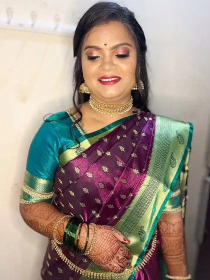 A close-up of her makeup. The eyes are softly defined, and the lip color is a beautiful shade that brightens her smile.