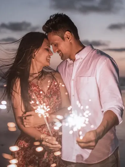 Let your love sparkle. Using props like sparklers can add a touch of magic and fun to your engagement photos. It’s a beautiful way to celebrate your new beginning as the sun sets.