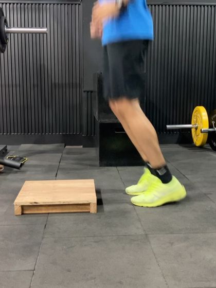 A demonstration of a box jump, emphasizing the explosive triple extension of the hips, knees, and ankles.