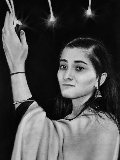 A dramatic portrait using a charcoal background to make the subject and the sparklers stand out. The light from the sparklers creates a beautiful glow effect.