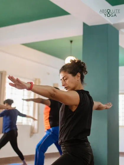 A student holds Warrior II with focus and determination. I guide you to find the depth in each posture, exploring the subtle layers of effort and ease that build both physical and mental resilience.