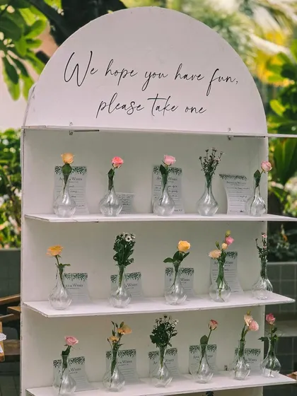 A thoughtful and interactive guest favor display for a baby shower. Each guest could take home a single flower in a vase, a lovely memento from a beautiful day.