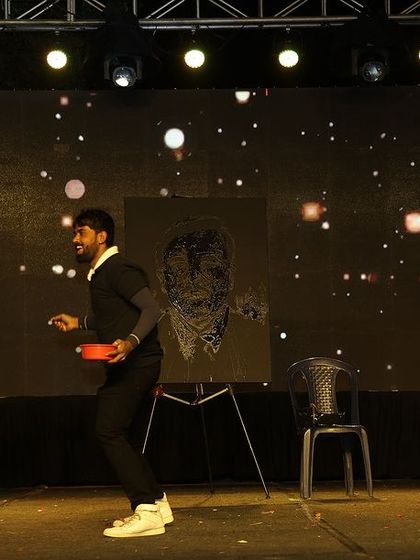 The moment before the reveal. I enjoy interacting with the audience and building a sense of excitement before I show them the finished artwork.