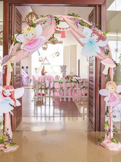 The magical entrance to a fairyland party. I designed this arch with whimsical fairy cutouts and soft drapery to welcome guests into an enchanted realm.