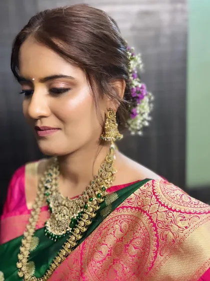 My stunning bride, ready for her engagement. This Maharashtrian look features soft, glowing makeup that complements her beautiful green and pink silk saree.