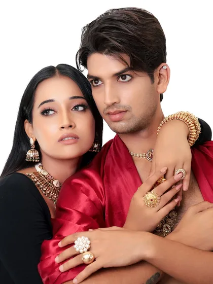 A royal couple's portrait. This shot captures the chemistry between the models, both adorned in stunning traditional jewelry and attire.