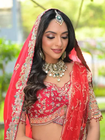 Draped in dreams. A beautiful shot of my bride in her red lehenga, with soft waves, smoky eyes, and perfectly draped dupatta.