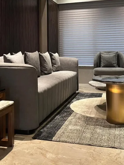 This angle shows how I use rugs to define seating areas. The abstract rug complements the clean lines of the sofa and the metallic sheen of the side table, adding warmth and texture to the marble floor.
