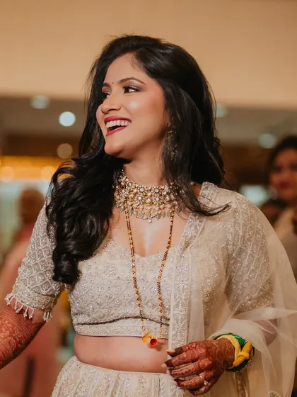 A candid shot of my reception bride Sejal, laughing and enjoying her celebration. Her soft glam makeup and ivory lehenga create a look of pure joy and elegance.