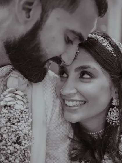 A black and white shot that captures the deep emotion between the couple. Her smile and the way she looks at him say it all.