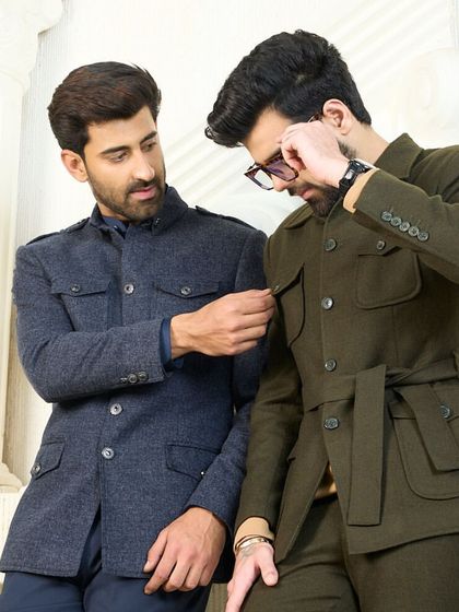 Two models display the navy and olive co-ord sets, demonstrating the fine details and craftsmanship that go into each piece.