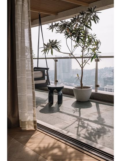 The view from the master bedroom onto the deck, where a potted Champa tree casts beautiful shadows throughout the day.