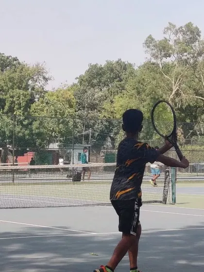 A young player prepares to hit a forehand during a competitive match at the TPL-ITA tournament. Real match experience is vital for development.