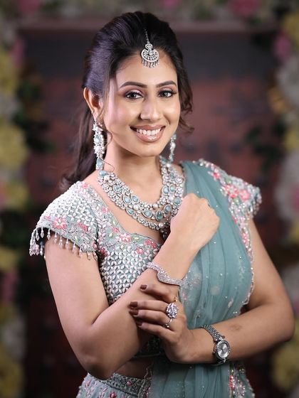 Another happy portrait of the model in the pastel blue lehenga, showing the complete rental look.