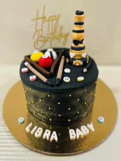 A sophisticated black and gold cake for a "Libra Baby" who loves pool and hookah. The top features a miniature pool table and a fondant hookah.