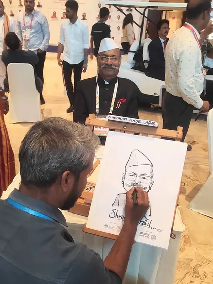 My art isn't just for weddings. Here I am sketching Member of Parliament Shri. Shrinivas Patil during the National Legislators Conference. It shows how live caricatures can be a unique and engaging feature for even the most formal corporate or government events.