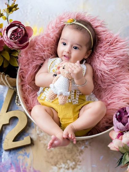 Celebrating six months with flowers and smiles. This half-birthday session captures the sweet and happy nature of this beautiful baby girl.