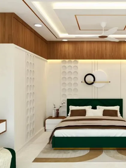 A sophisticated bedroom with a deep green velvet bed and a white 3D-paneled accent wall. The wood and gold details add warmth and luxury.