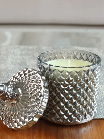 The shimmer of our silver Crystal Cove candle. The cut-glass jar catches the light beautifully, making it a stunning decorative piece for any modern or classic interior.