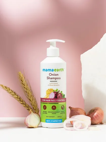 We used dramatic lighting to cast interesting shadows in this ingredient-focused shot for an onion shampoo. The composition with raw onions and stone props feels earthy and powerful.